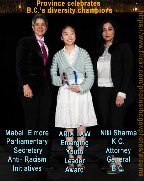 Aria Law, Emerging Youth Leader, between Mabel Elmore, MLA Parliamentary secretary for anti-racism & Niki Sharma, KC  A.G.